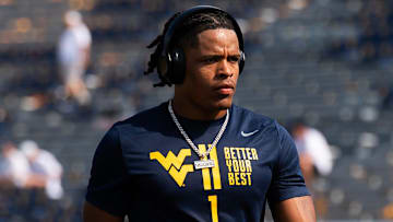 West Virginia running back Jahiem White warms up before the start of an NCAA football game against Penn State, Saturday, August 31, 2024, in Morgantown, W. Va.