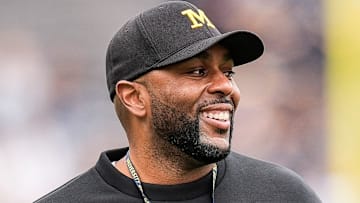 Michigan head coach Sherrone Moore smiles at players as he watches the first half of the spring game