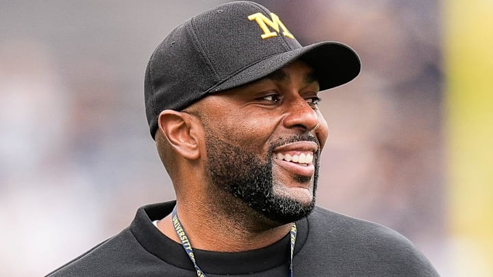Michigan head coach Sherrone Moore smiles at players as he watches the first half of the spring game