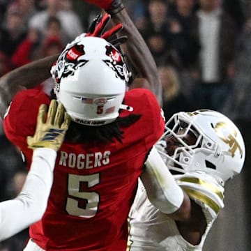 Nov 1, 2025; Raleigh, North Carolina, USA;  North Carolina State Wolfpack wide receiver Noah Rogers attempts to catch the ball against Georgia Tech Yellow Jackets defensive back Omar Daniels (9) during the second quarter at Carter-Finley Stadium. Mandatory Credit: Zachary Taft-Imagn Images