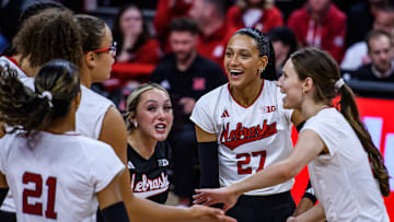 Harper Murray (27) smiles along with her teammates after the Huskers’ first point of the spring match. 
