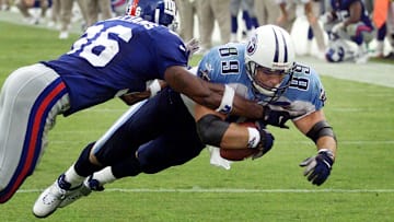 Tennessee Titans tight end Frank Wycheck (89) dives in the end zone past New York Giants defender Shaun Williams at Adelphia Stadium Oct. 1, 2000. The Titans 28-14 victory set a new NFL record for victories, 10, after opening a new stadium.

Text Gw 100100 Titans Giants