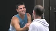 Carlos Alcaraz and Andy Murray shake hands after Alcaraz's loss to Novak Djokovic.
