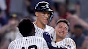 Jazz Chisholm Jr., Aaron Judge and Anthony Volpe (left to right) celebrate Judge's walk-off sacrifice fly against the Mariners Thursday.