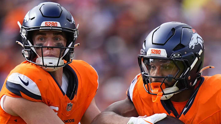 Sep 7, 2025; Denver, Colorado, USA; Denver Broncos running back J.K. Dobbins (27) receives a hand off from quarterback Bo Nix (10) during the second half at Empower Field at Mile High. Mandatory Credit: Ron Chenoy-Imagn Images