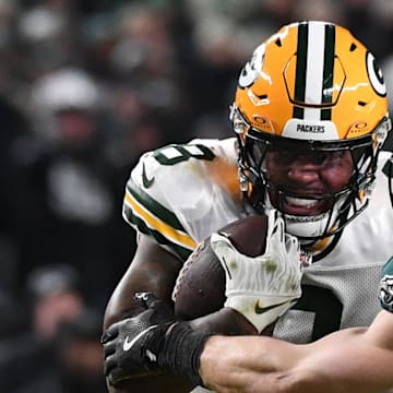 Green Bay Packers running back Josh Jacobs (8) rushes the ball against Philadelphia Eagles cornerback Cooper DeJean.