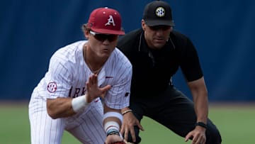 Ole Miss Rebels' Luke Hill (7) slides safely into second base before Arkansas Razorbacks' Cam Kozeal (8) can get the ball as Arkansas Razorbacks take on Ole Miss Rebels during the SEC baseball tournament at Hoover Met in Birmingham, Ala., on Friday, May 23, 2025.