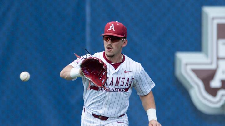 Arkansas Razorbacks' Logan Maxwell (22) catches a bouncing ground ball as Arkansas Razorbacks take on Ole Miss Rebels during the SEC baseball tournament at Hoover Met in Birmingham, Ala., on Friday, May 23, 2025.