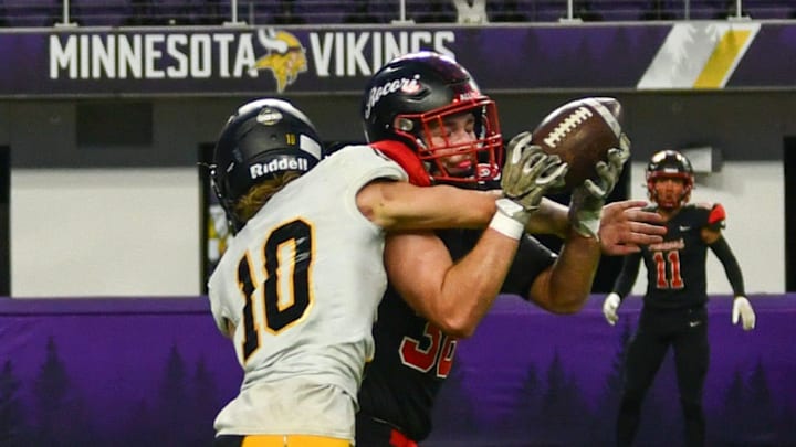 ROCORI football senior Kaden Rausch has a pass broken up by Byron's Kale Robinson on Nov. 16 in the Class 4A state semifinal football game. The Spartans won 7-0.