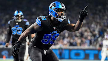 Former Detroit Lions defensive end Za'Darius Smith (99) celebrates a sack against Minnesota Vikings quarterback Sam Darnold (14) during the first half at Ford Field in Detroit on Sunday, Jan. 5, 2025.