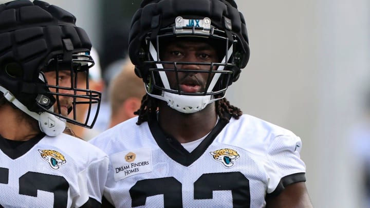 Jacksonville Jaguars linebacker Devin Lloyd (33) finishes a play against linebacker Trey Kiser (53) during the third day of an NFL football training camp practice Friday, July 26, 2024 at EverBank Stadium’s Miller Electric Center in Jacksonville, Fla.