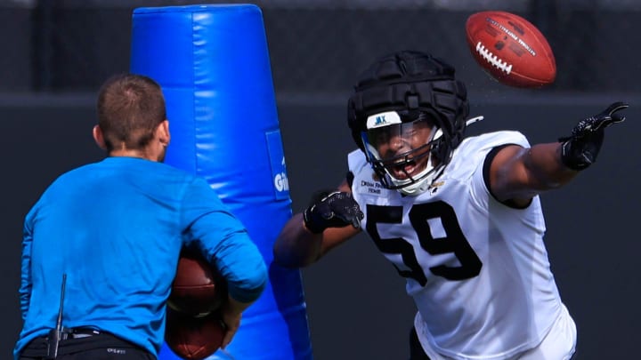 Jacksonville Jaguars linebacker Myles Cole (59) bats a pass down during the third day of an NFL football training camp practice Friday, July 26, 2024 at EverBank Stadium’s Miller Electric Center in Jacksonville, Fla.