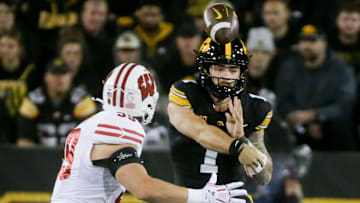 Iowa’s quarterback Brendan Sullivan (1) passes the ball as Wisconsin’s Aaron Witt (59) defends Saturday, Nov. 2, 2024 at Kinnick Stadium in Iowa City, Iowa.