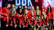 The Husker volleyball team poses with new head coach Dani Busboom Kelly