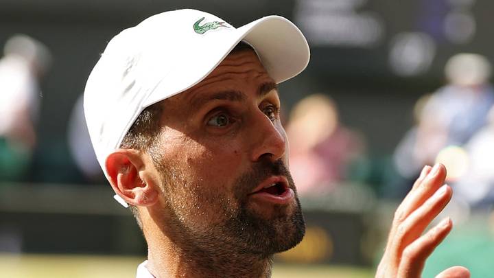 Novak Djokovic talks to his player's box