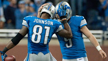 Detroit Lions quarterback Matthew Stafford congratulates wide receiver Calvin Johnson during the fourth quarter against the Atlanta Falcons.