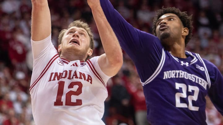 Indiana's Tucker DeVries (12) is blocked by Northwestern's Arrinten Page (22) during the Indiana versus Northwestern men's basketball game at Simon Skjodt Assembly Hall on Tuesday, Feb. 24, 2026.
