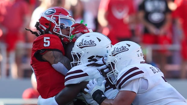Georgia Bulldogs wide receiver Anthony Evans III (5) is tackled by Mississippi State Bulldogs linebacker Nic Mitchell (40).