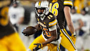 Oct 26, 2024; Laramie, Wyoming, USA; Wyoming Cowboys wide receiver Chris Durr Jr. (15) runs against the Utah State Aggies during the fourth quarter at Jonah Field at War Memorial Stadium. Mandatory Credit: Troy Babbitt-Imagn Images