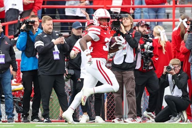 Kenneth Williams peeks back during his 95-yard kickoff return touchdown run.