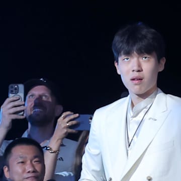 Jun 25, 2025; Brooklyn, NY, USA;  Yang Hansen walks to the stage after being selected as the 16th pick by the Memphis Grizzlies in the first round of the 2025 NBA Draft at Barclays Center. Mandatory Credit: Brad Penner-Imagn Images