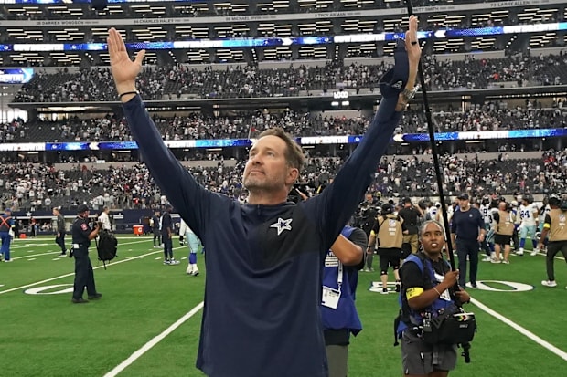 Dallas Cowboys head coach Brian Schottenheimer gestures to fans after the game against the New York Giants. 