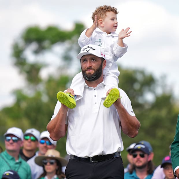 Jon Rahm holds his son on his shoulder during the Masters' Par-3 Contest.