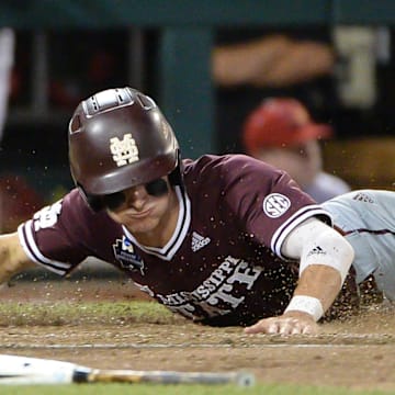 Jun 20, 2019; Omaha, NE, USA; Mississippi State Bulldogs outfielder Jake Mangum (15) scores a run in the seventh inning against the Louisville Cardinals in the 2019 College World Series at TD Ameritrade Park. Mandatory Credit: Steven Branscombe-Imagn Images