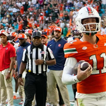Nov 8, 2025; Miami Gardens, Florida, USA; Miami Hurricanes quarterback Carson Beck (11) catches a touchdown pass against the Syracuse Orange during the second quarter at Hard Rock Stadium. Mandatory Credit: Jeff Romance-Imagn Images