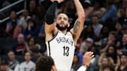 Mar 29, 2025; Washington, District of Columbia, USA; Brooklyn Nets guard Tyrese Martin (13) takes a shot over Washington Wizards guard Jordan Poole (13) during the first half at Capital One Arena. Mandatory Credit: Daniel Kucin Jr.-Imagn Images