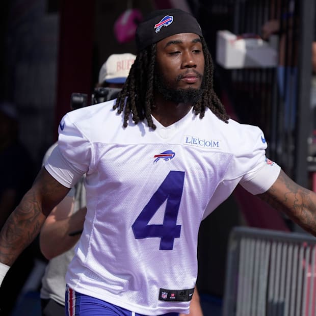 Buffalo Bills' running back James Cook greets some Bills fans during practice.