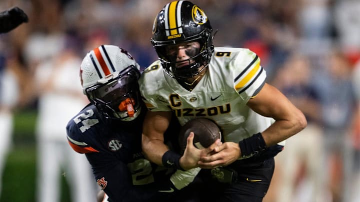 Missouri Tigers quarterback Beau Pribula (9) is tackled by Auburn Tigers buck Keyron Crawford (24) as Auburn Tigers take on Missouri Tigers at Jordan-Hare Stadium in Auburn, Ala. on Saturday, Oct. 18, 2025.