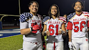 Sione Felila, left, shares a moment with Oak Hills HS teammates Nathan Cabrejo and Inoke Finau.