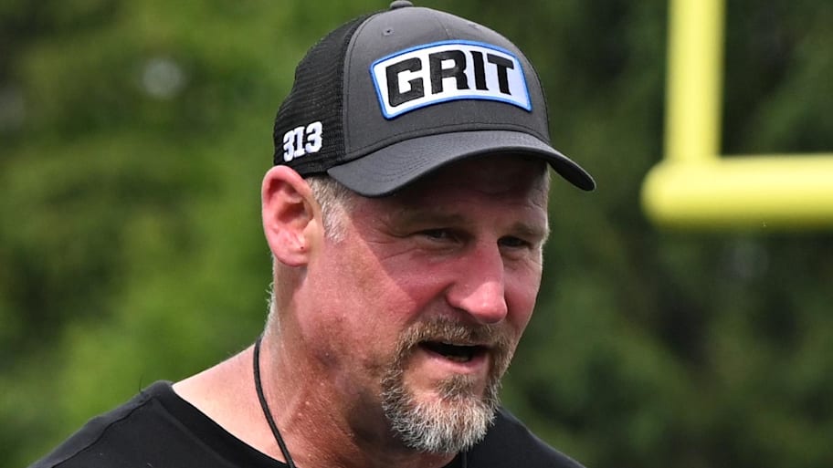 Detroit Lions head coach Dan Campbell talks with his assistants after training camp at team's Performance Center | Lon Horwedel-Imagn Images