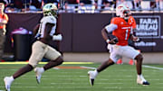 Oct 4, 2025; Blacksburg, Va.; Virginia Tech quarterback Kyron Drones (1) runs toward the sideline with the ball against Wake Forest linebacker Aiden Hall (21).