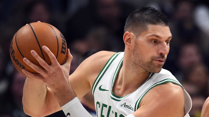 Feb 25, 2026; Denver, Colorado, USA; Boston Celtics center Nikola Vucevic (4) works in the post against Denver Nuggets guard Julian Strawther (3) during the first half at Ball Arena. Mandatory Credit: Christopher Hanewinckel-Imagn Images