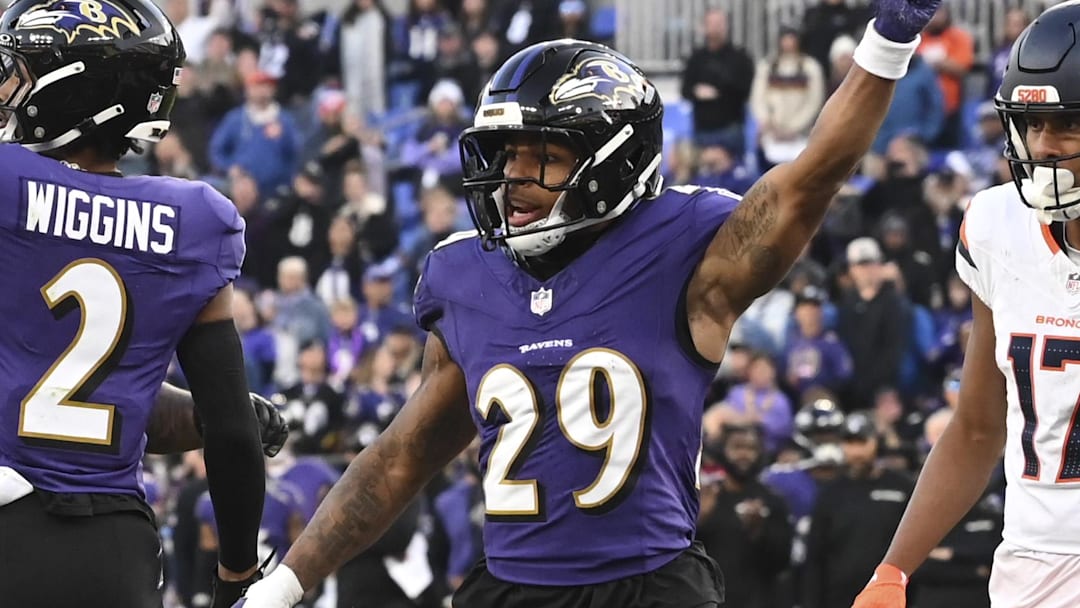 Nov 3, 2024; Baltimore, Maryland, USA; Baltimore Ravens cornerback Nate Wiggins (2) and =safety Ar'Darius Washington (29) celebrate after tackling Denver Broncos wide receiver Courtland Sutton (14) on the one yard line on fourth down  the  during the  half at M&T Bank Stadium. Mandatory Credit: Tommy Gilligan-Imagn Images
