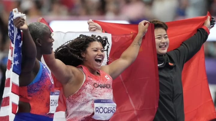 Camryn Rogers celebrates with fellow medal winners