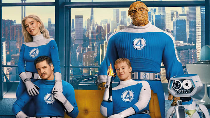 An image of the Fantastic Four sitting in their living room while wearing their costumes.