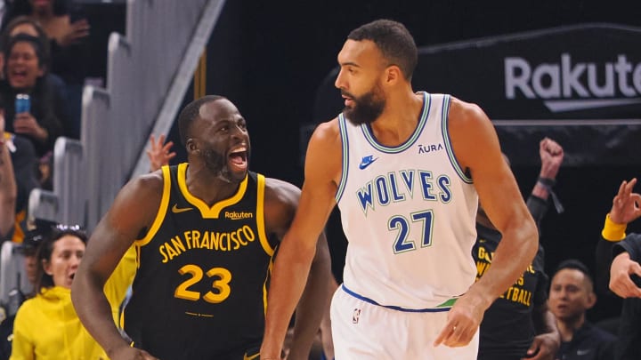 Nov 12, 2023; San Francisco, California, USA; Golden State Warriors forward Draymond Green (23) celebrates behind Minnesota Timberwolves center Rudy Gobert (27) after scoring a three point basket during the first quarter at Chase Center. 