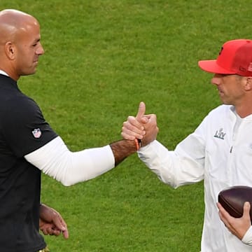 Feb 2, 2020; Miami Gardens, Florida, USA; San Francisco 49ers defensive coordinator Robert Saleh (left) and head coach Kyle Shanahan (right) shake hands prior to the game between the San Francisco 49ers and the Kansas City Chiefs in Super Bowl LIV at Hard Rock Stadium. Mandatory Credit: Jasen Vinlove-Imagn Images