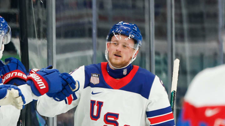 Feb 20, 2026; Milan, Italy; Jack Eichel (9) of the United States celebrates with the bench after scoring a goal during the second period against Slovakia in a men's ice hockey semifinal during the Milano Cortina 2026 Olympic Winter Games at Milano Santagiulia Ice Hockey Arena. Mandatory Credit: Geoff Burke-Imagn Images