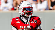 Oct 4, 2025; Raleigh, North Carolina, USA;  NC State Wolfpack quarterback CJ Bailey (11) looks to pass during the first half of the game against Campbell Fighting Camels at Carter-Finley Stadium. Mandatory Credit: Jaylynn Nash-Imagn Images