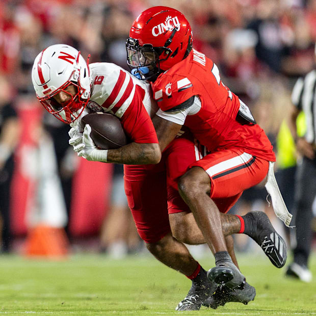 Nebraska wide receiver Dane Key is tackled by Cincinnati's Logan Wilson after picking up nine yards in Kansas City.