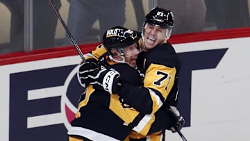 Oct 16, 2024; Pittsburgh, Pennsylvania, USA;  Pittsburgh Penguins center Sidney Crosby (87) and center Evgeni Malkin (71) celebrate after Crosby scored the game winning power play goal in overtime to defeat the Buffalo Sabres at PPG Paints Arena. Mandatory Credit: Charles LeClaire-Imagn Images