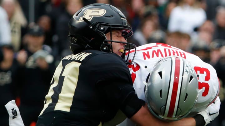 Purdue Boilermakers defensive back Dillon Thieneman tackles Ohio State Buckeyes quarterback Devin Brown