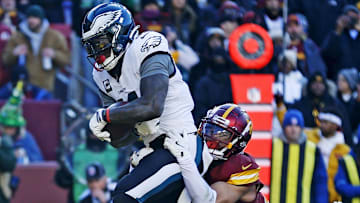 Dec 22, 2024; Landover, Maryland, USA; Philadelphia Eagles wide receiver A.J. Brown (11) catches a touchdown pass against Washington Commanders cornerback Marshon Lattimore (23) during the first quarter at Northwest Stadium. Mandatory Credit: Peter Casey-Imagn Images