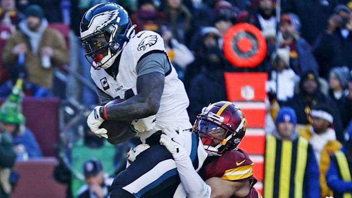Dec 22, 2024; Landover, Maryland, USA; Philadelphia Eagles wide receiver A.J. Brown (11) catches a touchdown pass against Washington Commanders cornerback Marshon Lattimore (23) during the first quarter at Northwest Stadium. Mandatory Credit: Peter Casey-Imagn Images