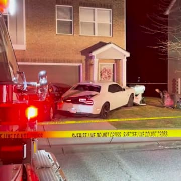 The scene after a Georgia football player is reported to have crashed his car into the front of an apartment house.