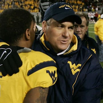 West Virginia Mountaineers head coach Rich Rodriguez hugs quarterback White after defeating the Louisville Cardinals in 2007.